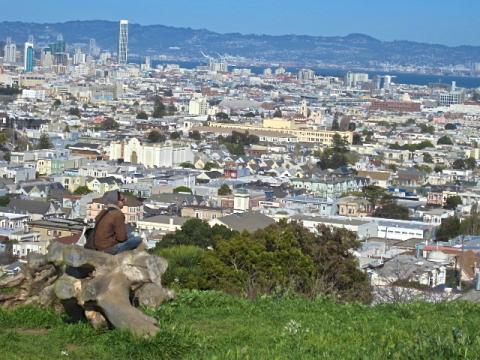 Sitting on a rock of a hill in San Francisco